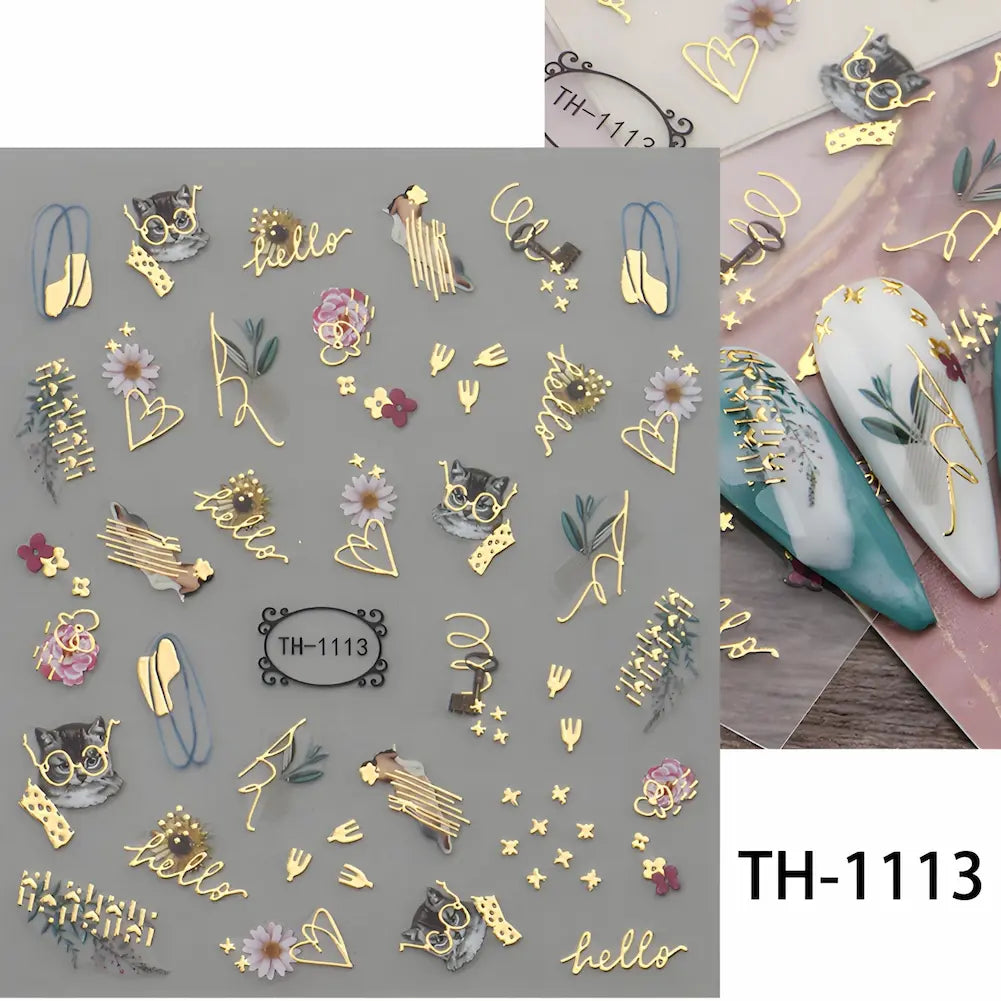 Adesivos para unhas com desenhos diversos em dourado, incluindo flores, corações e palavras como "hello". Código: TH-1113.