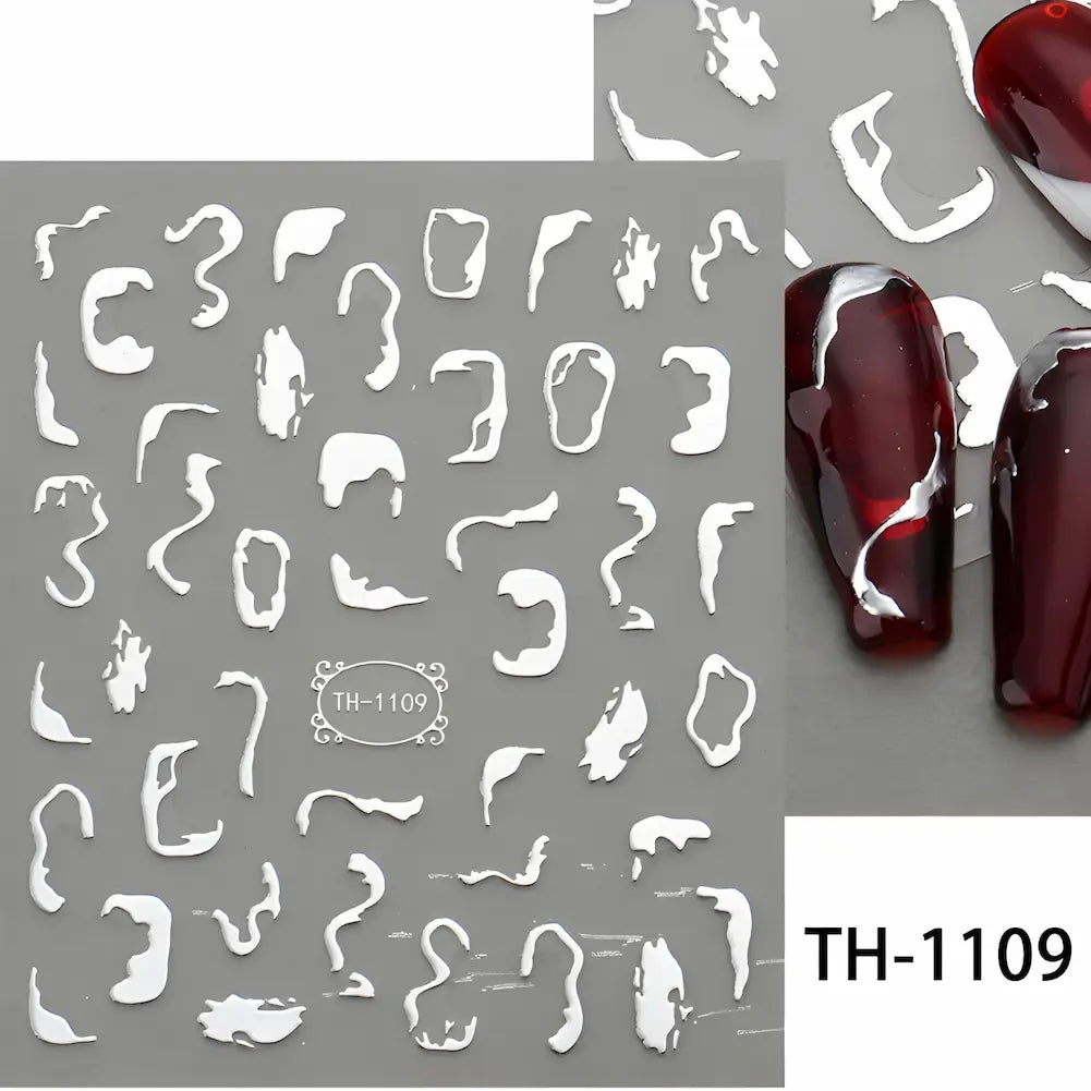 Adesivos abstratos para unhas em branco, com formas orgânicas e geométricas, aplicados em unhas com esmalte vermelho. Código: TH-1109.