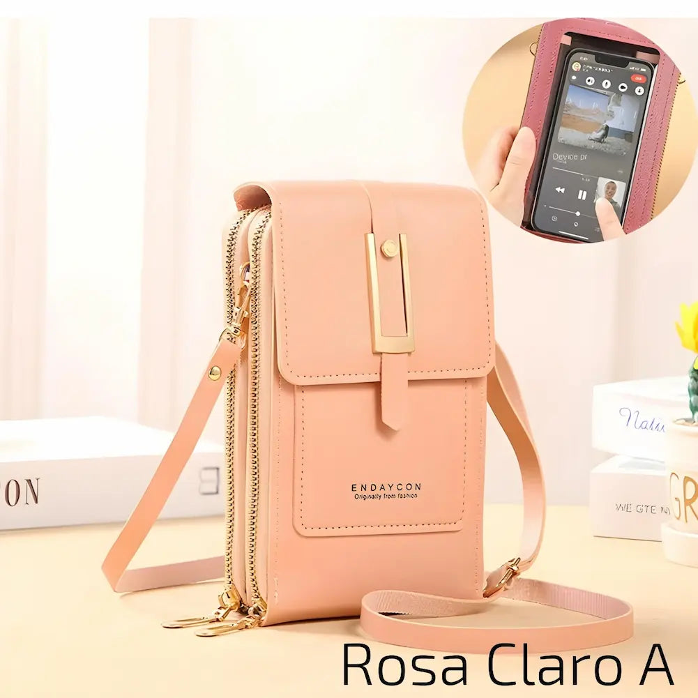 Uma bolsa pequena e elegante, feita de couro rosa claro, com alça ajustável. Possui um fecho metálico dourado e dois zíperes laterais. Na frente, há um bolso com o nome da marca "ENDAYCON". No canto inferior direito, o código "Rosa Claro A", uma das opções de compra.