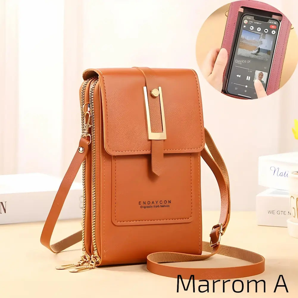 Esta bolsa marrom é de couro com uma alça ajustável. Tem um fecho metálico dourado no centro e dois zíperes laterais. Na frente, o nome da marca "ENDAYCON" está estampado. No canto inferior direito, o código "Marrom A", uma das opções de compra.