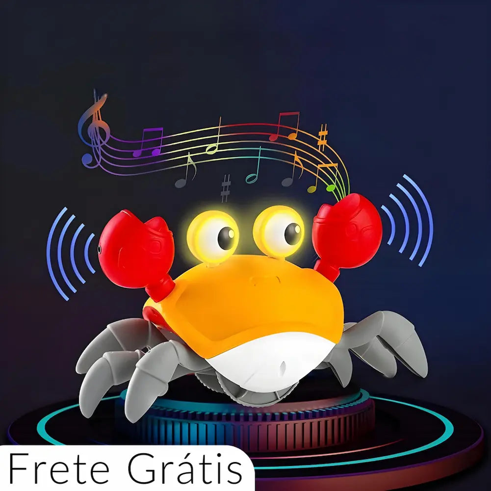 A imagem apresenta um brinquedo interativo em forma de caranguejo com corpo laranja e branco, garras vermelhas e pernas cinzas. O caranguejo está em destaque com um fundo escuro, emitindo luzes dos olhos e cercado por notas musicais coloridas, indicando que toca música. Ondas sonoras azuis ao lado das garras sugerem que o caranguejo também emite som. Na parte inferior esquerda da imagem, há um texto que diz "Frete Grátis".