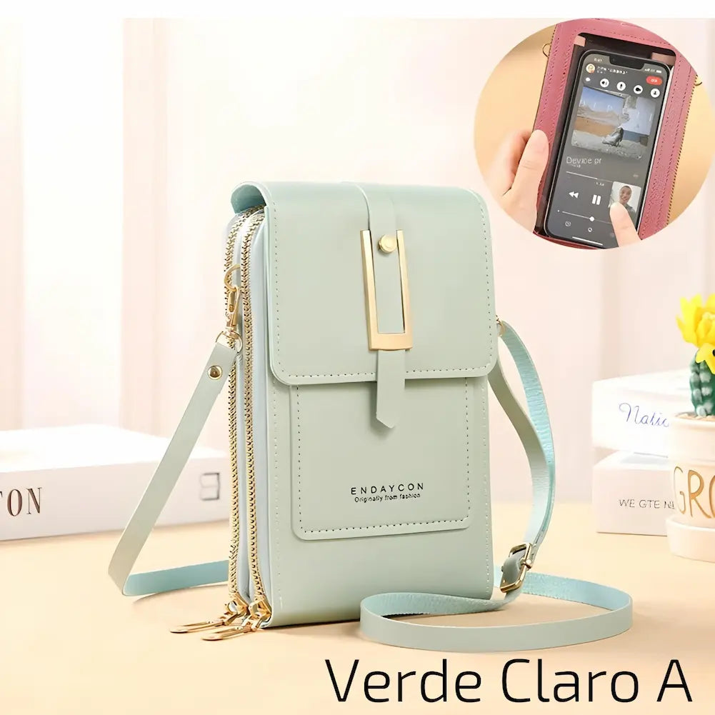 Uma bolsa pequena e elegante, feita de couro rosa claro, com alça ajustável. Possui um fecho metálico dourado e dois zíperes laterais. Na frente, há um bolso com o nome da marca "ENDAYCON". No canto inferior direito, o código "Rosa Claro A", uma das opções de compra.