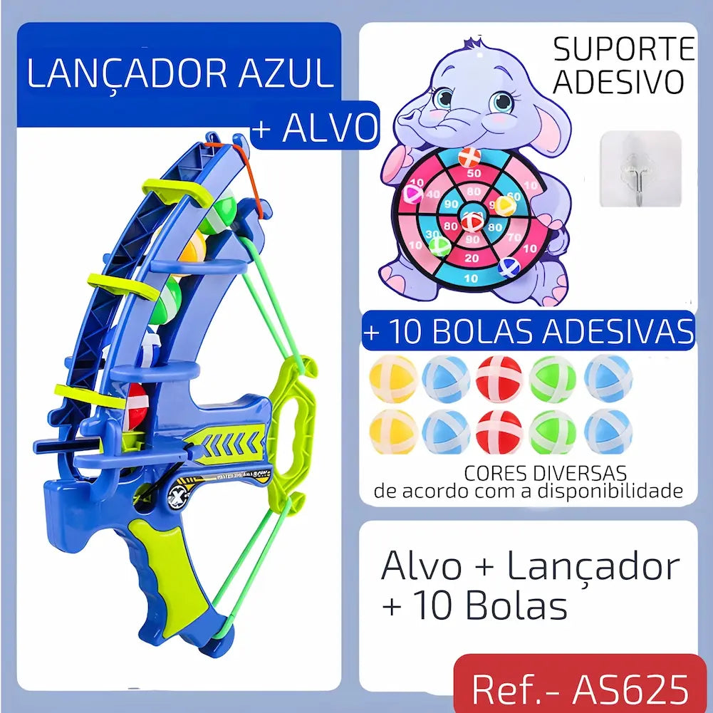 Ref. AS625 Imagem mostrando um lançador azul com alça verde, acompanhado de um alvo de elefante e 10 bolas adesivas coloridas. Inclui suporte adesivo para fixação.