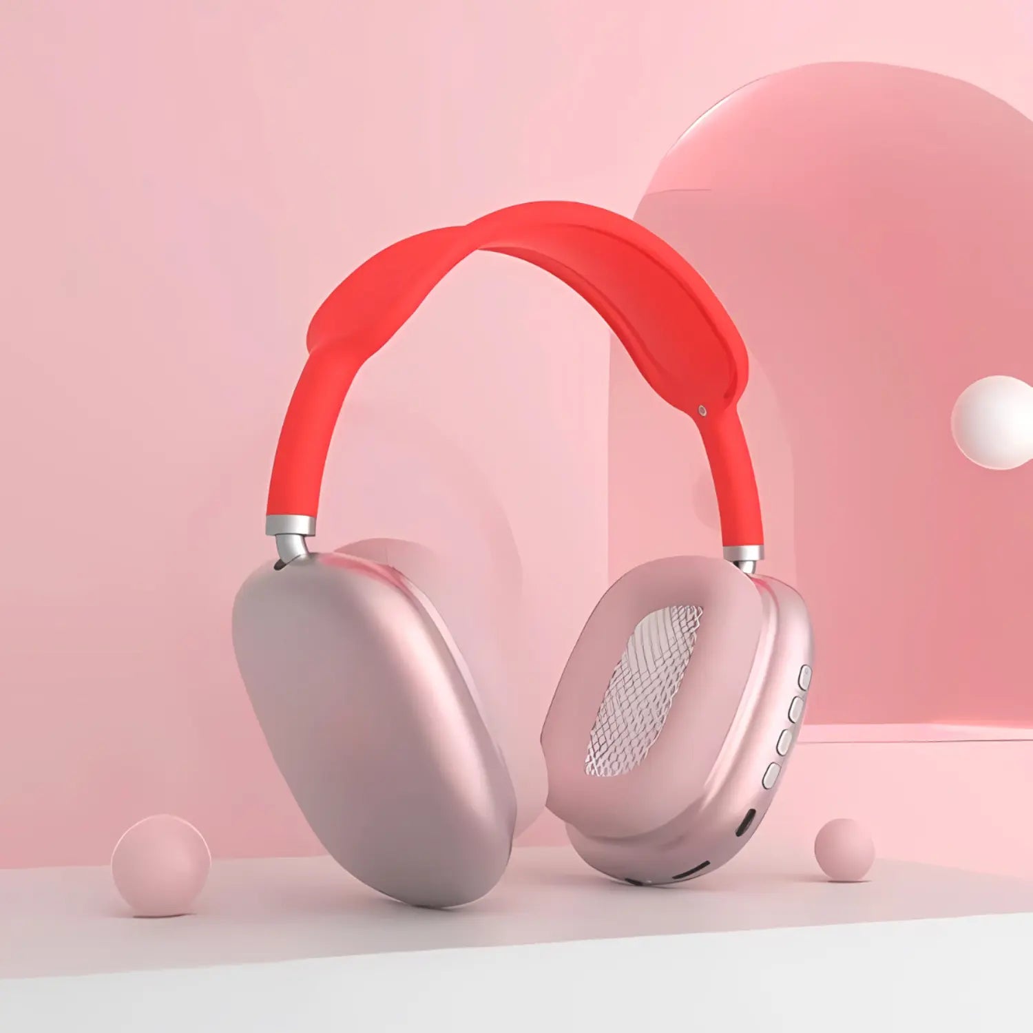 A imagem mostra um headphone moderno com almofadas de ouvido metálicas rosé e uma faixa de cabeça vermelha. O design é elegante e contemporâneo, destacando-se pelo contraste de cores vibrantes. Há botões visíveis na lateral direita das almofadas, indicando controle fácil e acessível. O fundo suave e minimalista em tons de rosa complementa o estilo jovem e arrojado do fone. A composição transmite um visual fresco e estiloso.