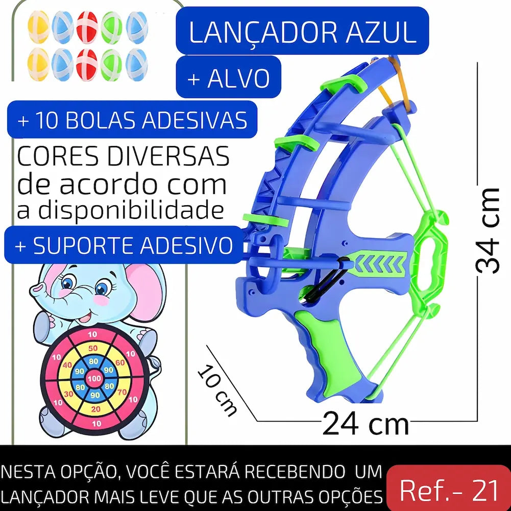 Ref. 21 Imagem de um lançador azul com alça verde, acompanhado de um alvo de elefante e 10 bolas adesivas coloridas. Inclui suporte adesivo para fixação. As medidas do lançador são 34 cm de altura por 24 cm de largura.